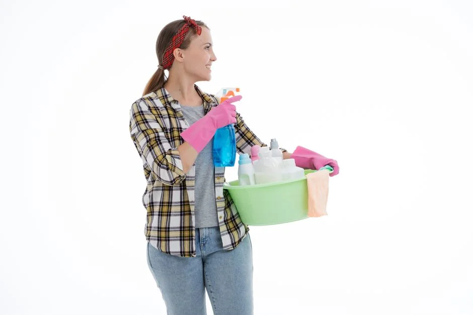 An adult male cleaning a glass window indoors, focusing on household chores and cleanliness.